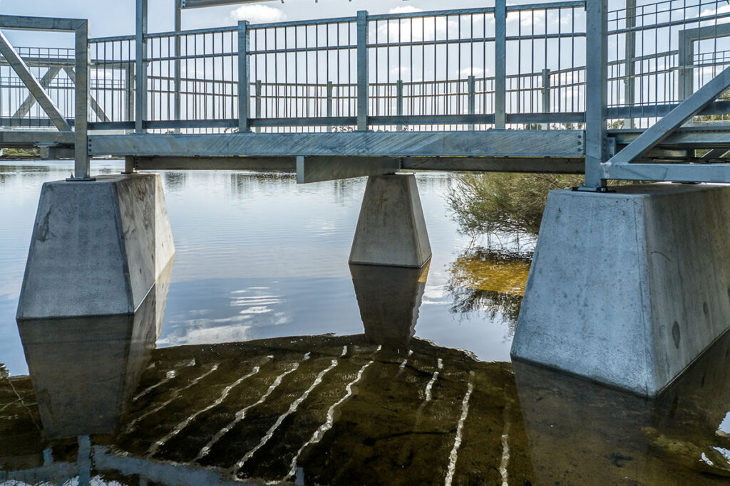 pedestrian bridge concrete footings in water